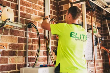 Technician installing a home solar battery system
