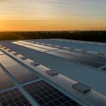 Rooftop solar panel installation at sunset